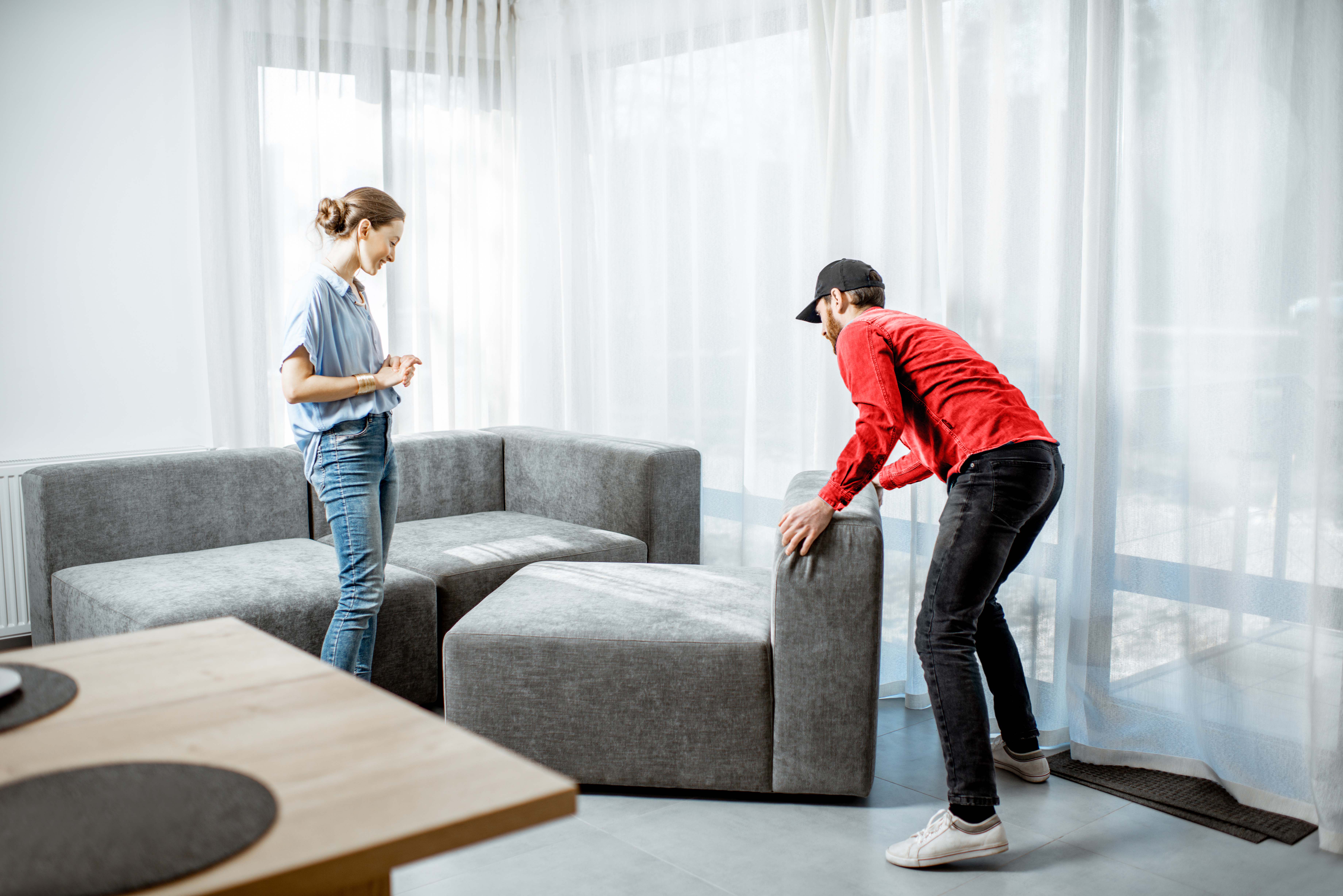 Desert Moving mover helping customer arrange furniture in new home