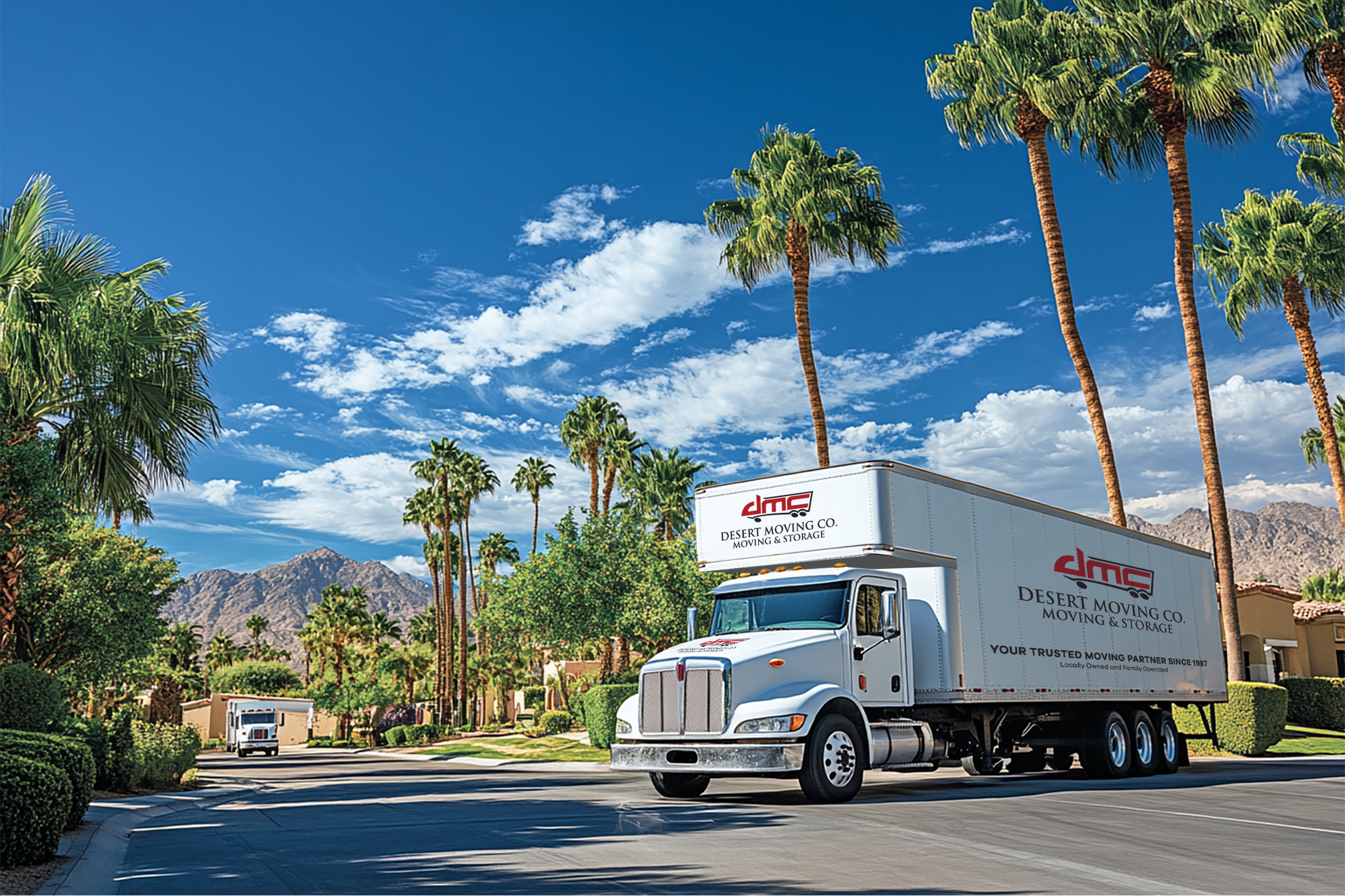 Two DMC branded trucks driving through Palm Springs neighborhood