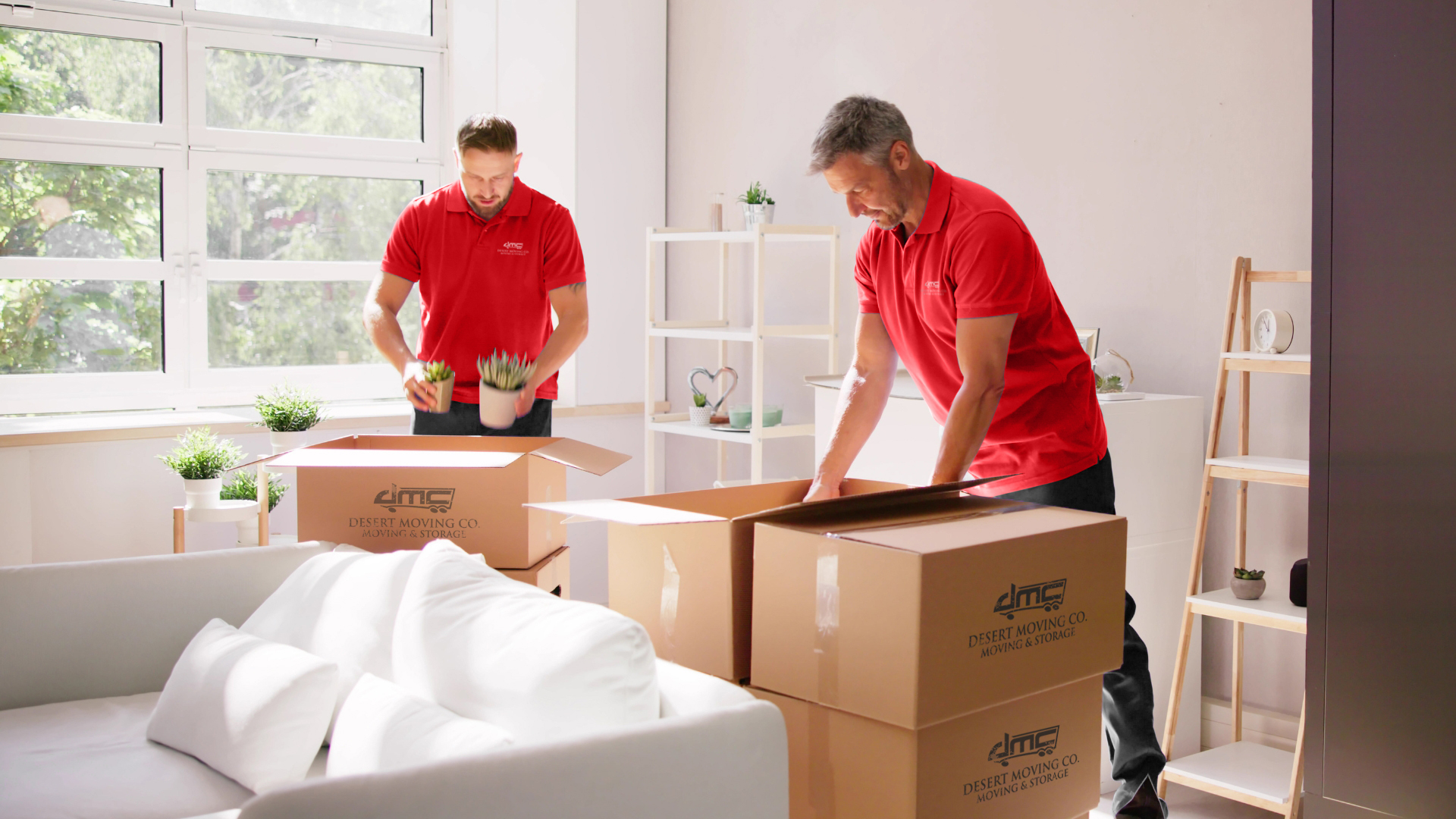 Desert Moving crew packing branded boxes in a residential home